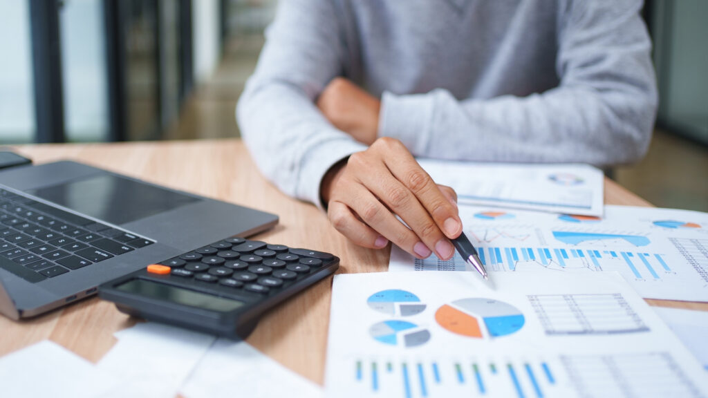 Business owner reviewing financial reports to value a business before selling